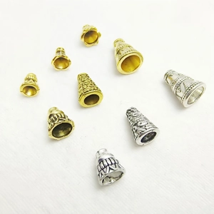 Various sizes of gold and silver alloy bead caps for jewelry making on white background