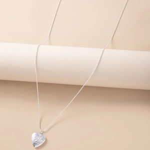 Silver heart locket necklace with footprint engraving on a beaded metal chain