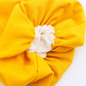 Elegant off-shoulder puff sleeve maxi dress in vibrant yellow and white fabric texture
