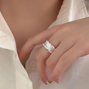 Detail of minimalist 925 sterling silver wide ring with irregular wrinkled texture