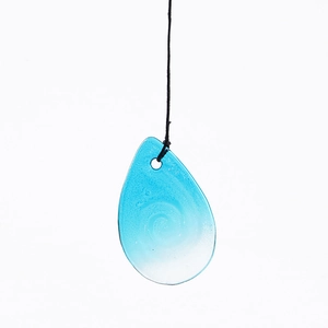 Detailed view of teardrop glass pendant with blue gradient and internal bubble texture