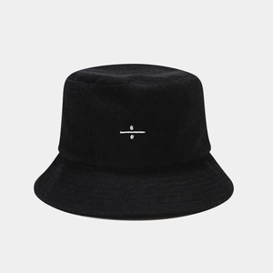 Detail of white symbol embroidery on black terry cloth bucket hat fabric texture
