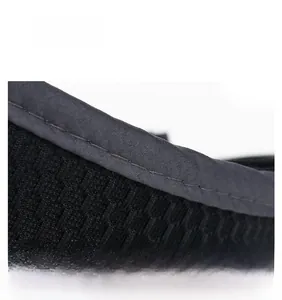 Detail of reinforced double-stitched seams and mesh texture on the black sun visor hat