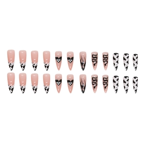 Long almond cow print press-on nails with black heart and flame designs for women