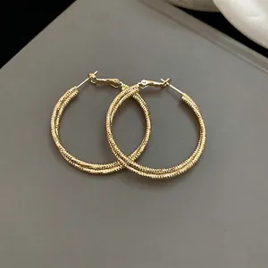 Fashionable golden textured hoop earrings with woven design for women daily style