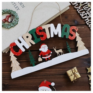 Detail of wooden Merry Christmas hanging sign with Santa and reindeer on wood table