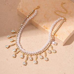 Double-layered gold necklace with pearls and iridescent teardrop crystal pendants