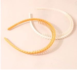 Detail of yellow and ivory matte headbands with non-slip teeth for secure styling