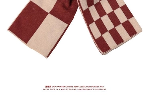 Detail shot of red and white checkerboard knit scarf showing thick woven texture