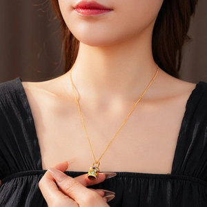 Close-up of vintage golden flower basket necklace with colorful enamel and zircon inlay