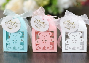 Laser cut bear gift boxes in blue, pink, and white with silk ribbons and thank you tags