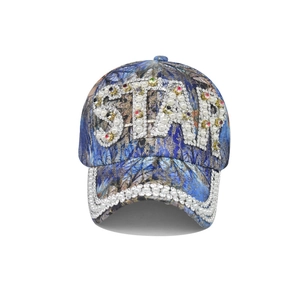 Detail of blue baseball cap with pearl STAR lettering and rainbow rhinestone accents