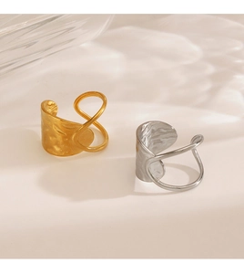 Close-up of hammered texture on gold and silver geometric rings with light ripple shadow