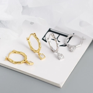 Detail view of irregular S925 silver wavy earrings with square zircon pendants in gold and silver