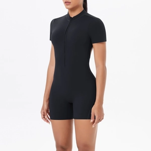 Detail of black slim-fit yoga romper featuring high collar and front zipper closure