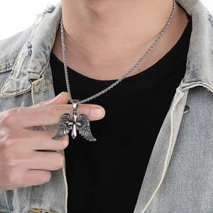 Close-up of model wearing punk angel wing and cross pendant in stainless steel