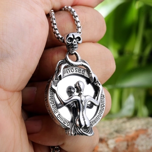 Detailed close-up of a punk stainless steel skull mirror pendant with gothic relief