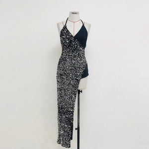 Detail of the halter neckline and sequin embroidery on the asymmetrical evening dress