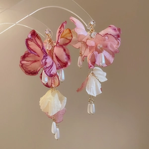 Detail of pink fabric flower earrings with faux pearls and sparkling rhinestone studs