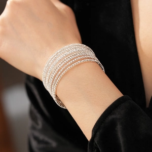 Close-up of sparkling silver multi-layer rhinestone wrap bracelet on a model's wrist