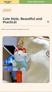 Detail of Maneki Neko lucky cat leather keychain with gold clasp on a white canvas bag