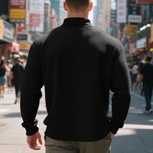 Rear view of black waffle texture jacket on model with urban street background