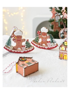 Detail of wooden gingerbread man pendant with warm glowing lights for Christmas tree decoration