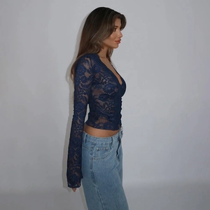 Detailed side view of navy blue slim-fit lace top with intricate floral mesh pattern