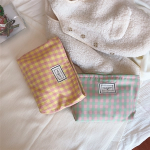 Close-up of colorful checkered cotton makeup bags with a TIME TO PARTY fabric label