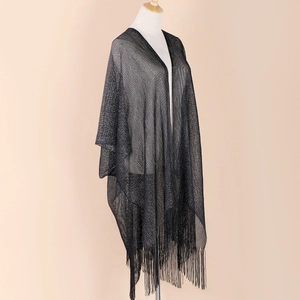 Side view of black semi-transparent shawl with long tassels on a mannequin display