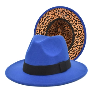 Detail of royal blue wool fedora hat featuring leopard print lining and black ribbon