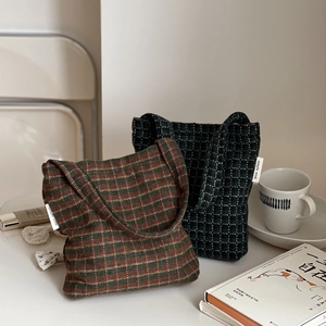 Close-up of wool plaid handbags featuring fabric texture and Simple Wish brand tag