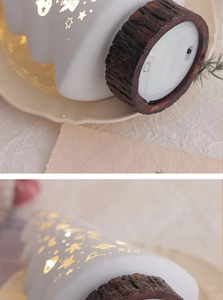 Detail view of glowing star cutouts on white ceramic tree and battery base