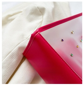 Detail of rose red leather tote with colorful rhinestones and Romantic Time text