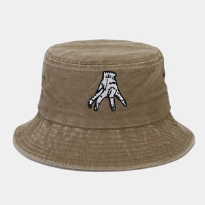 Detail of hand embroidery on washed cotton bucket hat with metal eyelets and vintage finish