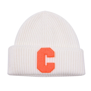 Detailed view of white ribbed knit beanie with an orange chenille letter C patch