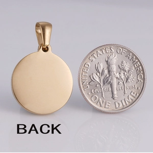 Macro view of gold stainless steel necklace pendant back with a coin for scale