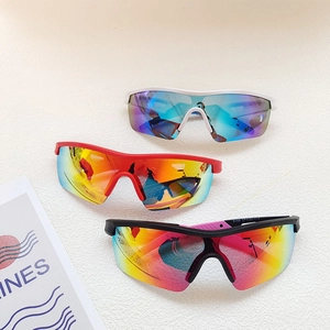 Close-up of kids cycling sunglasses showing white, red and black frames with colorful lenses