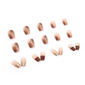 Caramel gradient press-on nails with gold foil accents and 3D heart charms