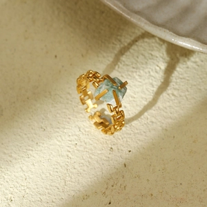 Detail of adjustable gold-plated chain ring featuring an irregular green natural stone