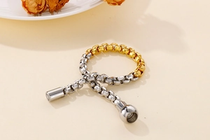 Detail of two-tone gold and silver square link chain with magnetic clasp closure