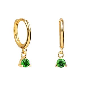 Close-up of gold huggie hoop earrings featuring round-cut green zircon drops on white base