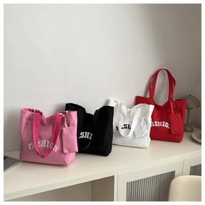 Detail showing high-capacity canvas tote bags in four colors with matching mini pouches