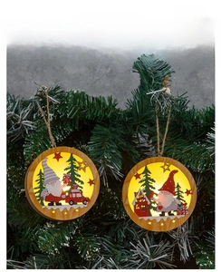 Close-up of lighted wooden Christmas gnome ornament hanging on a festive green pine tree
