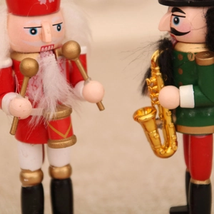 Close-up detail of wooden Christmas nutcracker figurines playing drum and saxophone