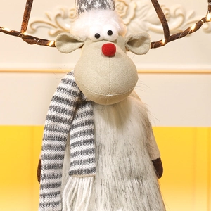 Close-up of plush Christmas reindeer with glowing LED light antlers and striped scarf