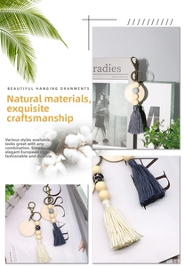 Detail of Nordic wooden bead keychain with cotton tassel and leopard print pattern