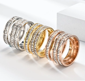 Detail of three-tone titanium steel rings with four-layer interwoven cubic zirconia design