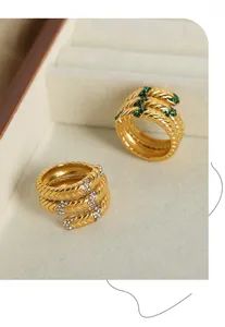 Makroansicht goldener Schlangenringe mit Schuppenstruktur und eingelegten Zirkonia