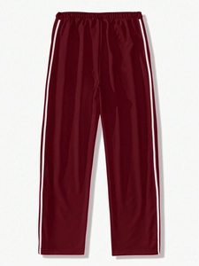 Detail of burgundy sweatpants featuring elastic waist and iconic white side stripes